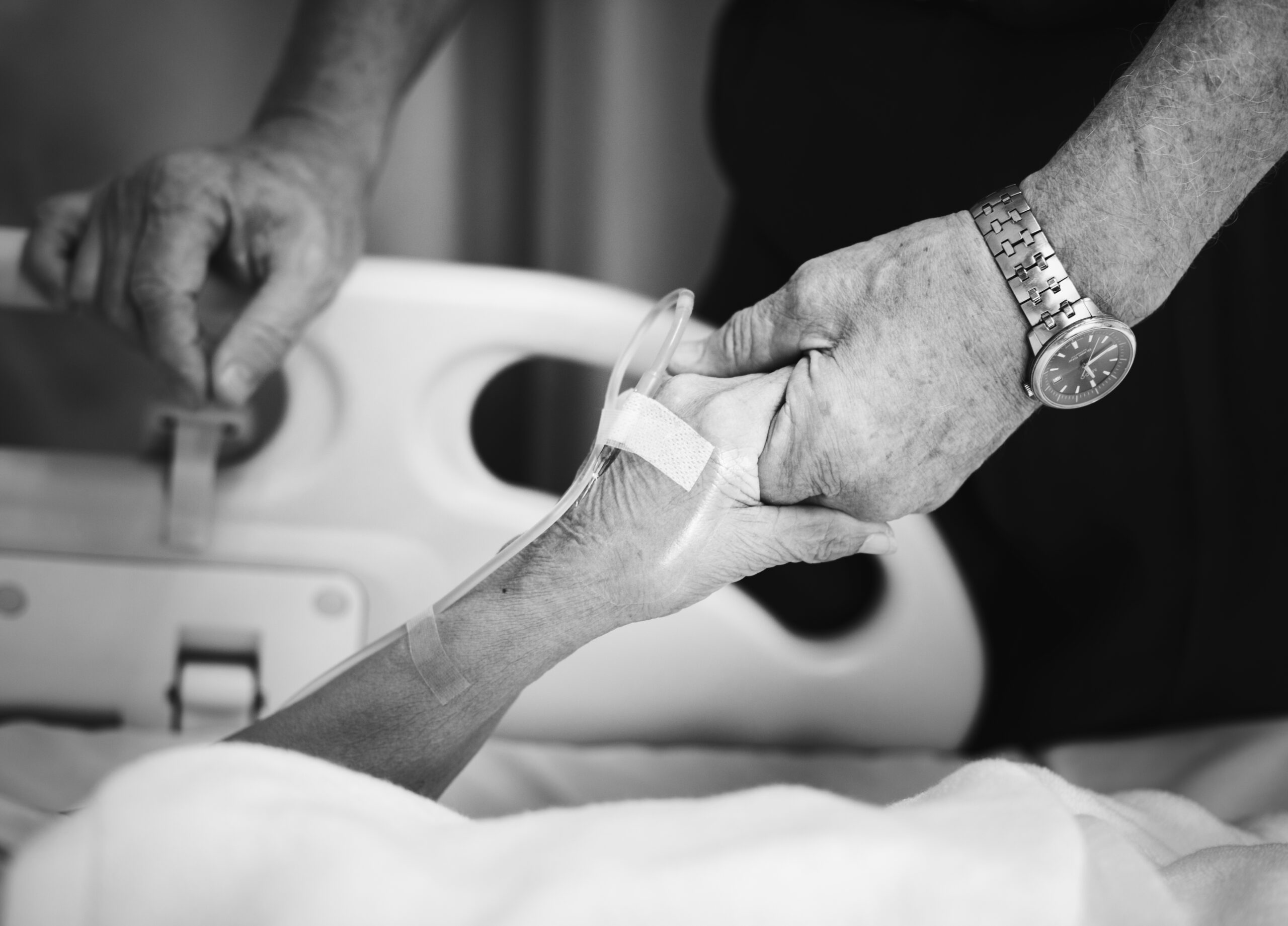 Husband holding hands of his wife in a hospital Husband holding hand with his wife in a hospital